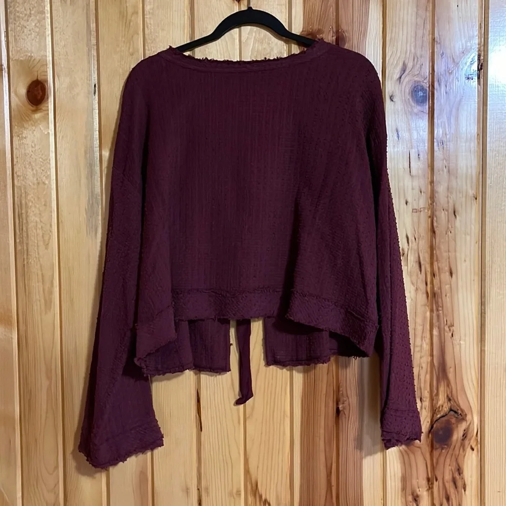 Free People Walking in Hueco Back Tie Long Sleeve Raspberry Cropped Top.